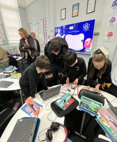 BETT visitor talking to children about their work